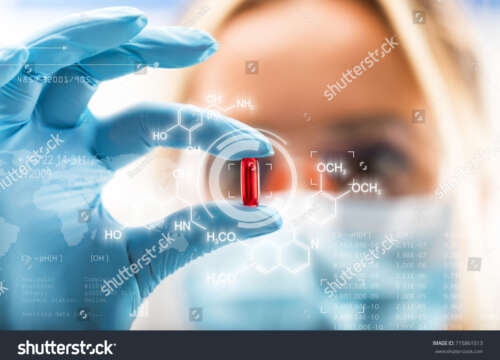 stock-photo-young-attractive-female-scientist-holding-a-red-transparent-pill-with-futuristic-scientific-air-715861513